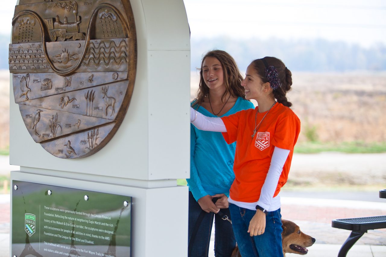 Girls viewing sculpture at Towpath Trailhead