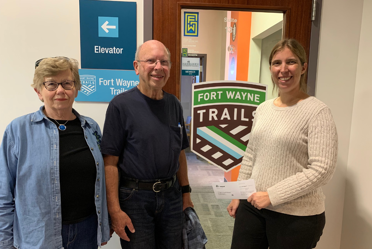 donors presenting a check to executive director megan mcclellan